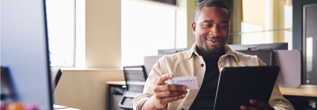 Person holding an insurance card for Carelon Behavioral Health