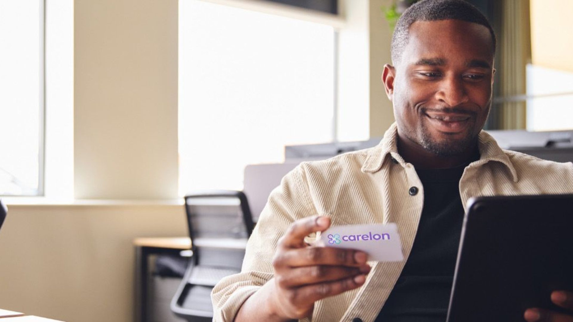 Person holding an insurance card for Carelon Behavioral Health