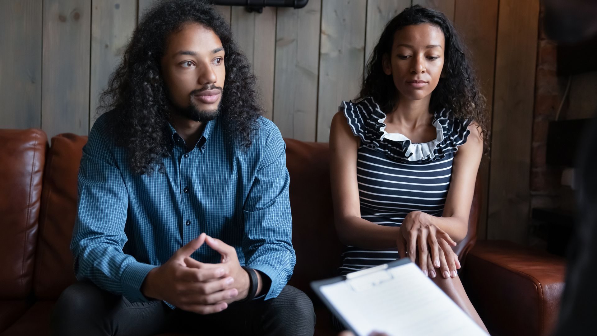 A couple listen attentively in a therapy session