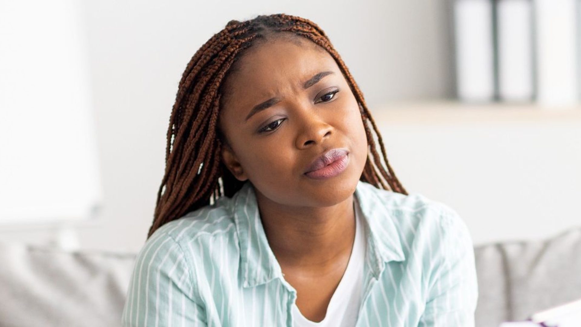 A person in therapy deep in thought and concerned.