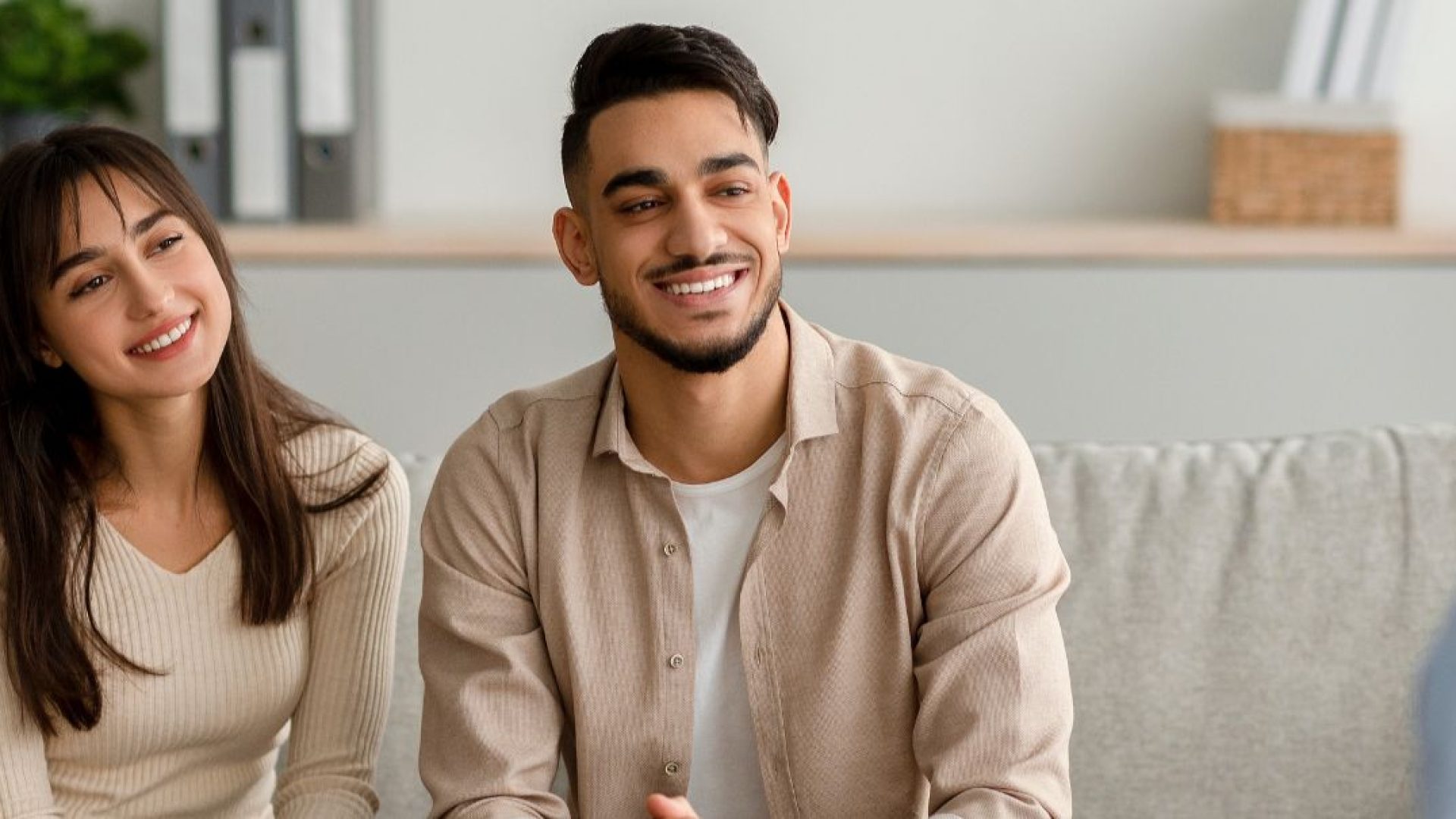 A happy couple talks to their therapist.