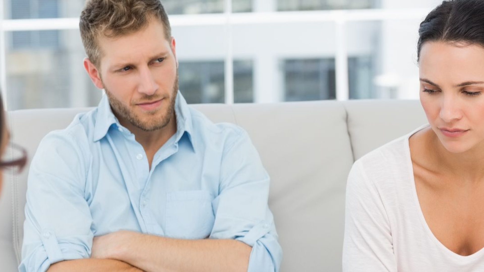 A couple talks to a therapist, both of them are unhappy and seem to be blaming each other.