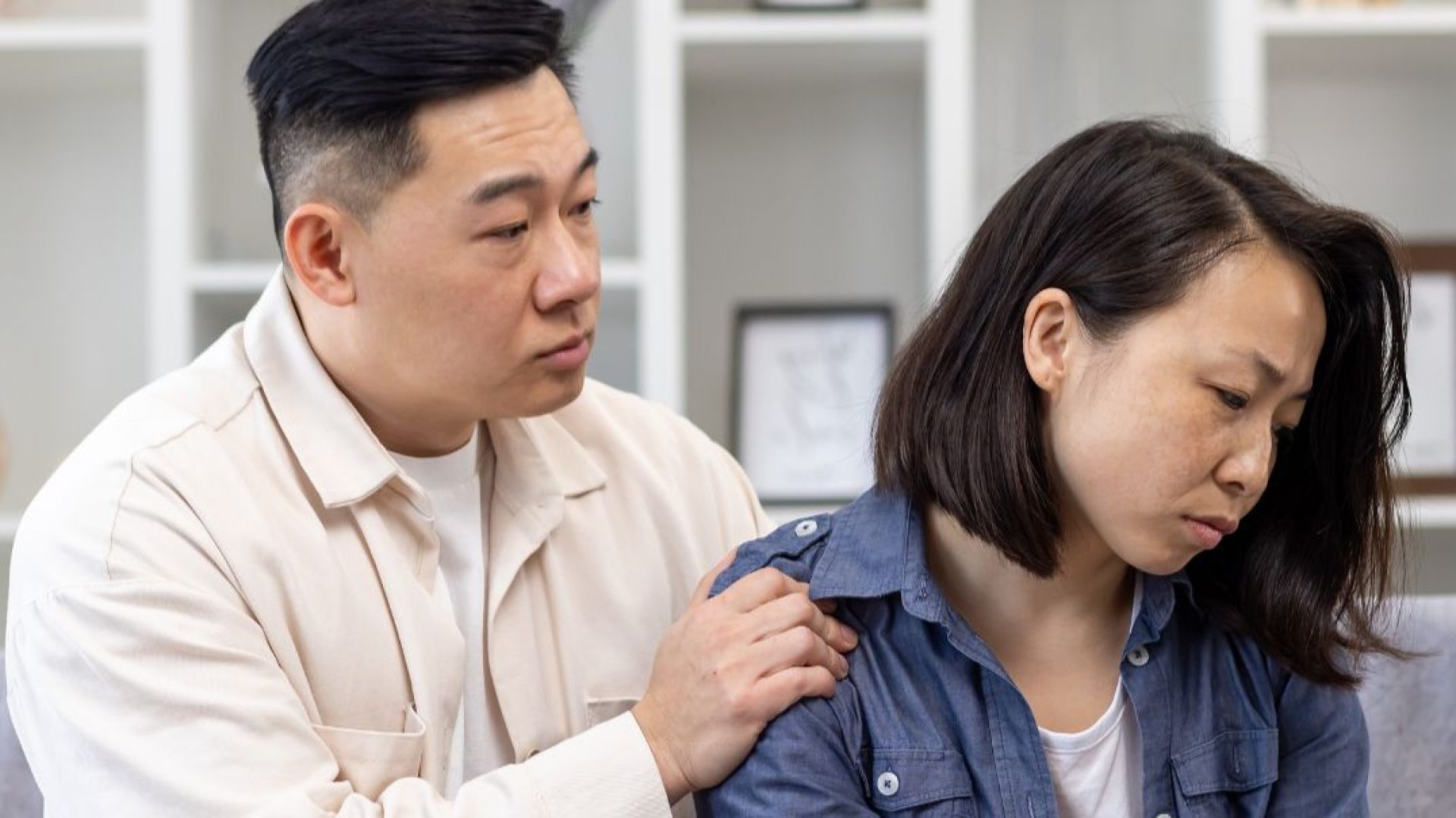 A man tries to comfort his devastated wife.