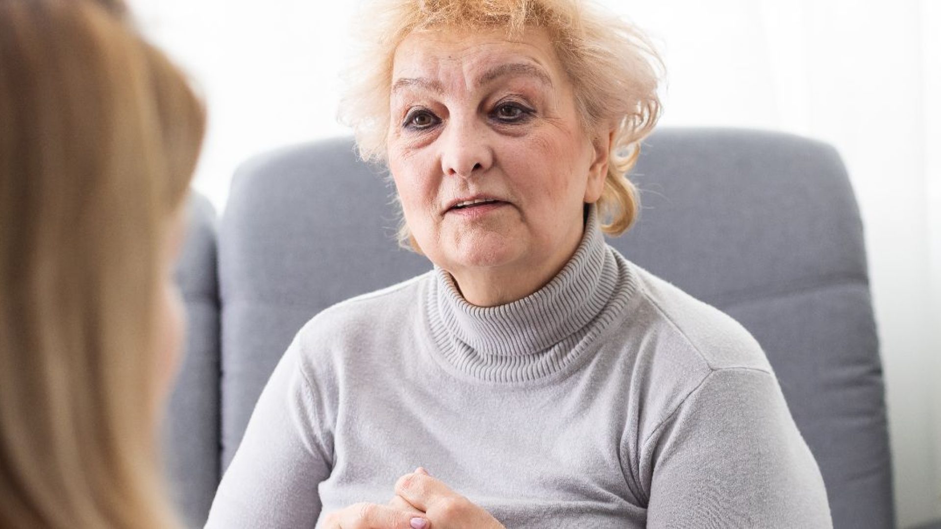 Person at a therapist's office, receiving treatment for Depersonalization-Derealization Disorder.