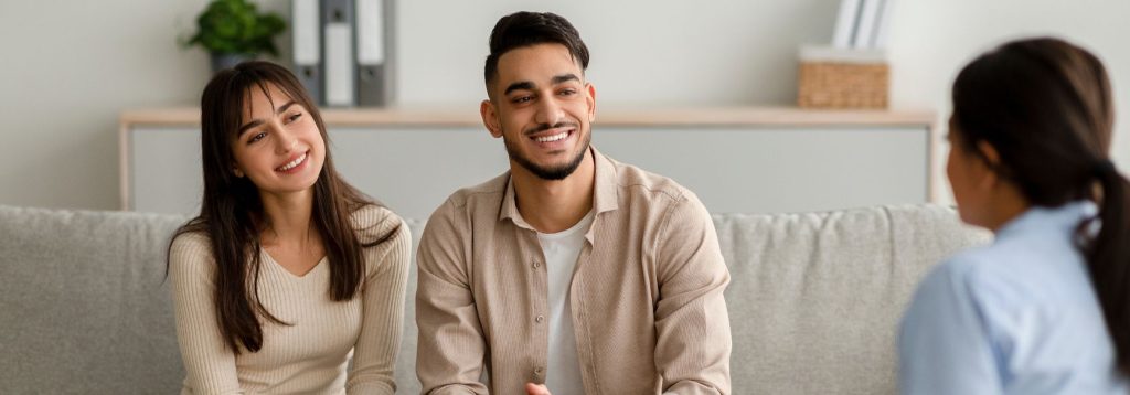 A happy couple talks to their therapist.