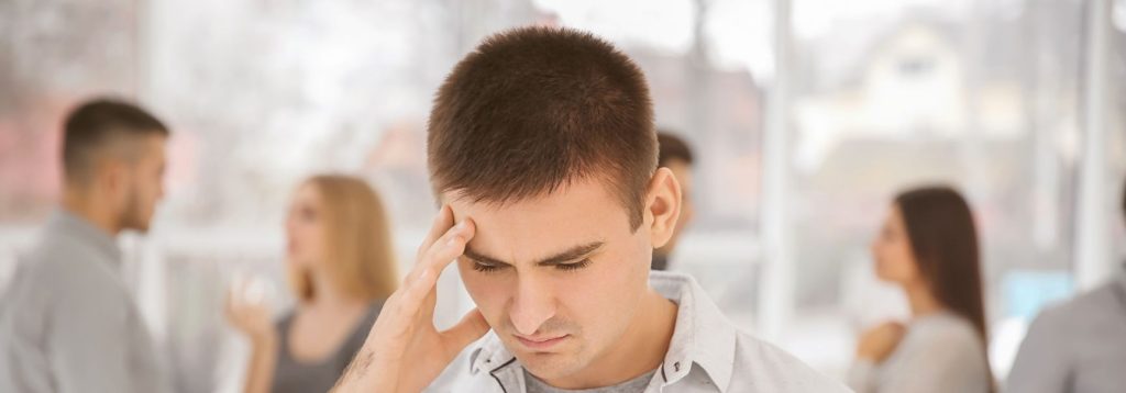 Someone feeling anxious in a crowded room.