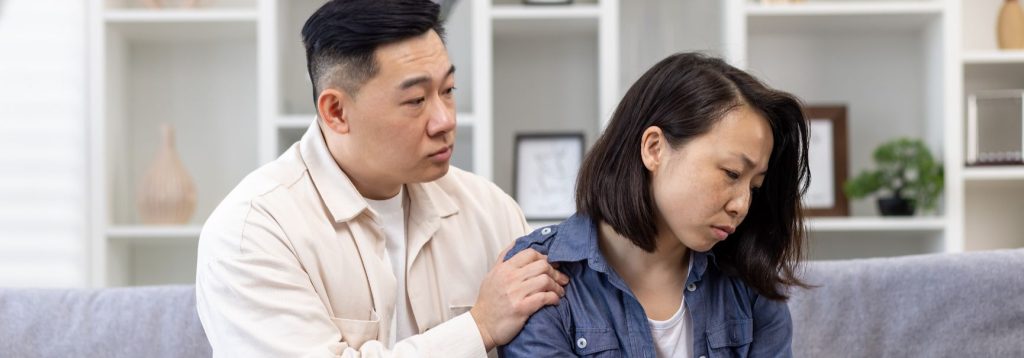 A man tries to comfort his devastated wife.
